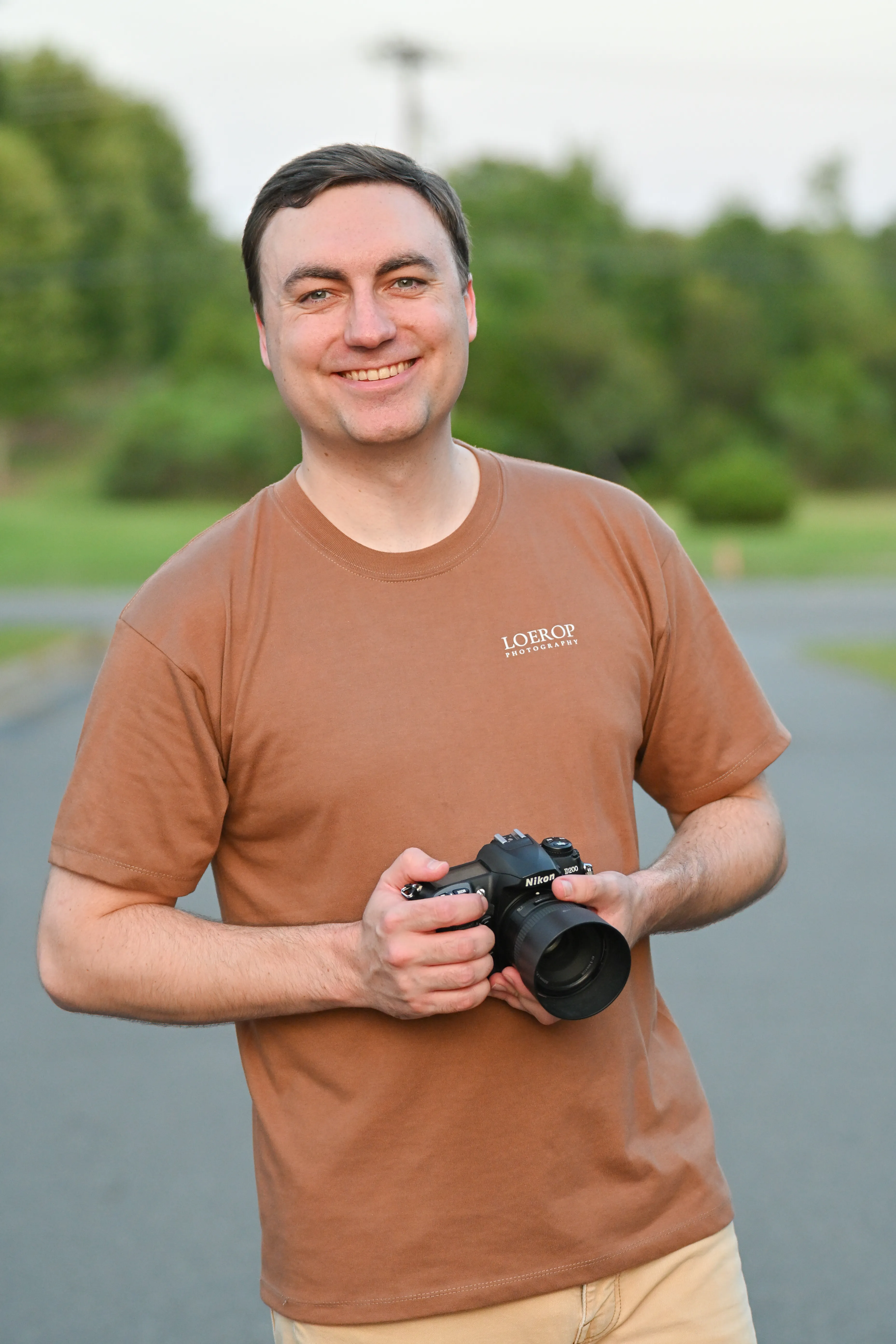 Mike Loerop holding his camera in a Loerop Photography shirt, Charlotte, North Carolina wedding photographer