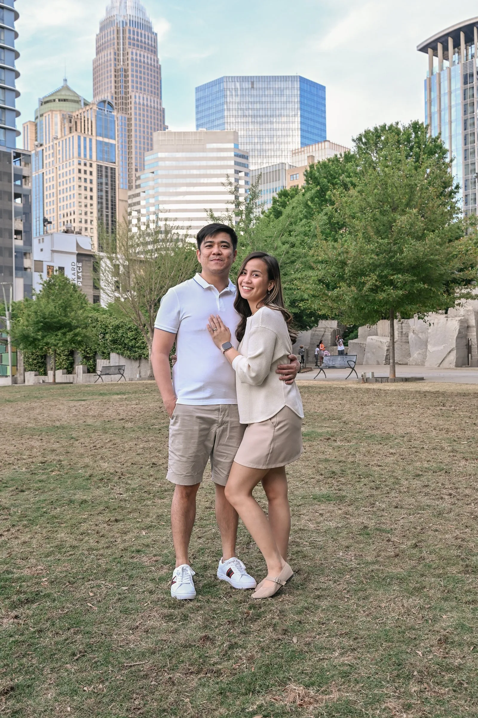 Wide portrait of Jessica and Jet beneath the Charlotte skyline