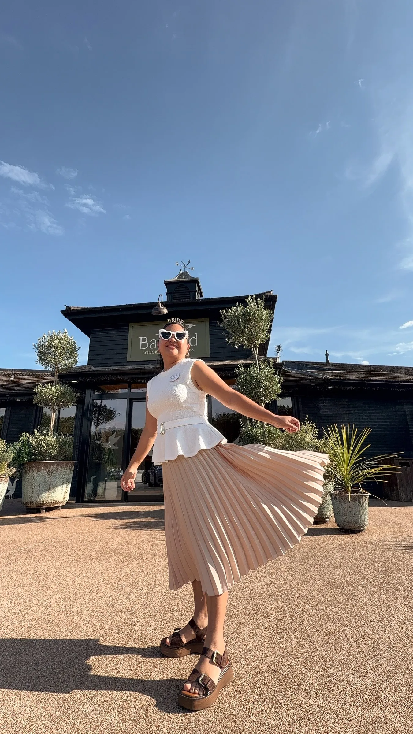 Mathelle twirling her pleated skirt outside the Bainland lodge