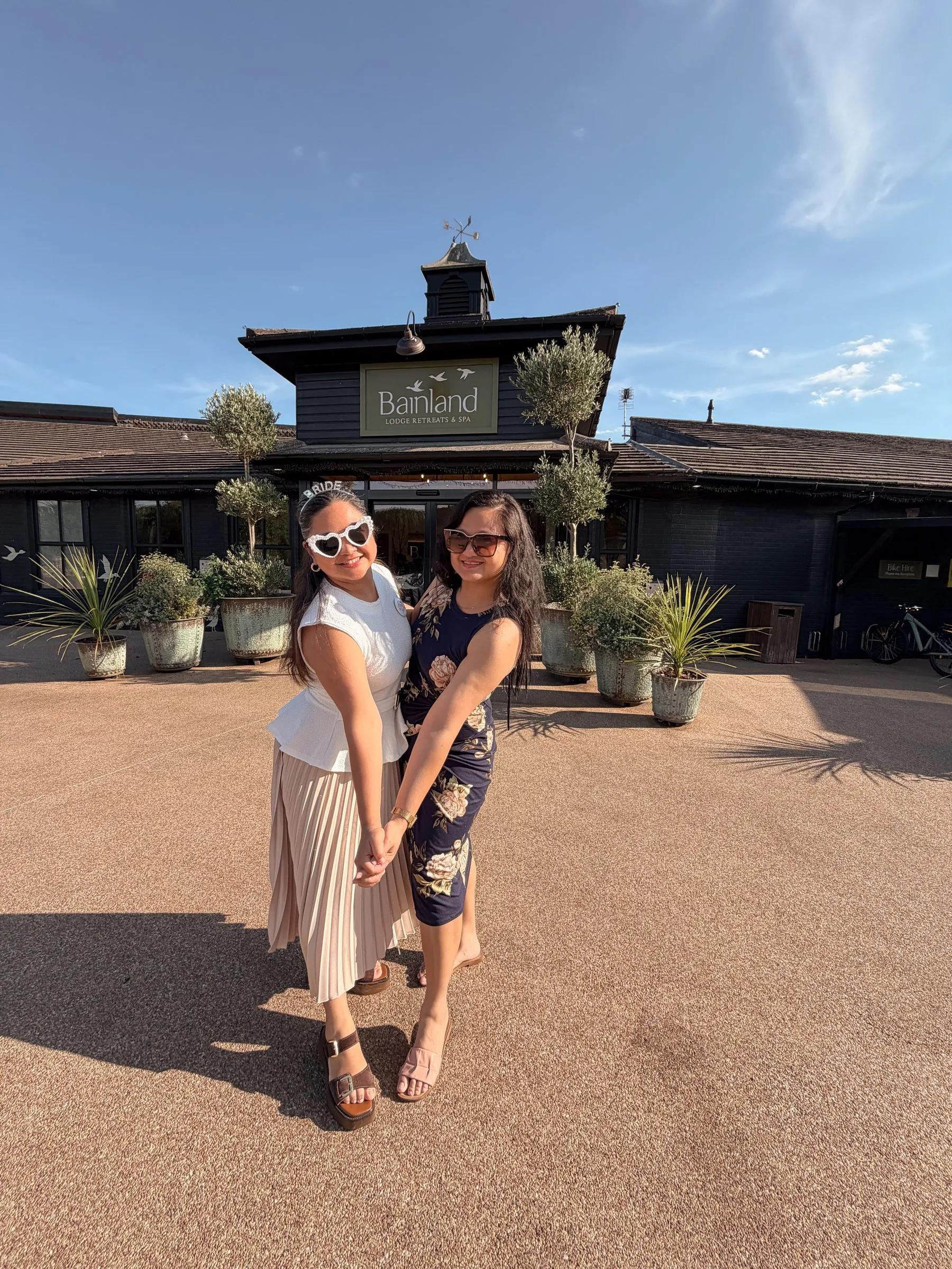 Mathelle and a friend posing arm in arm outside the lodge