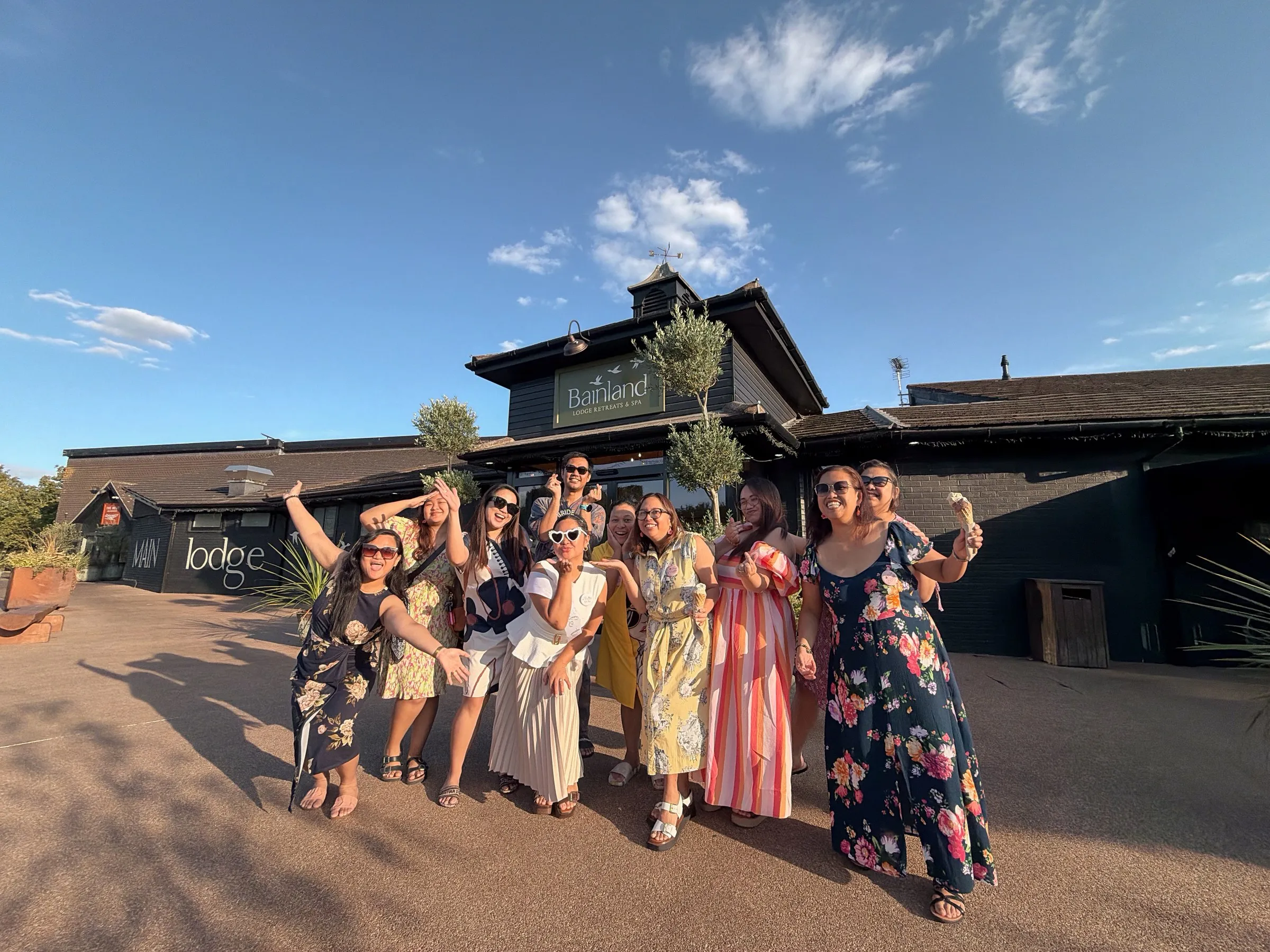 The whole bachelorette group cheering outside Bainland Lodge Retreats