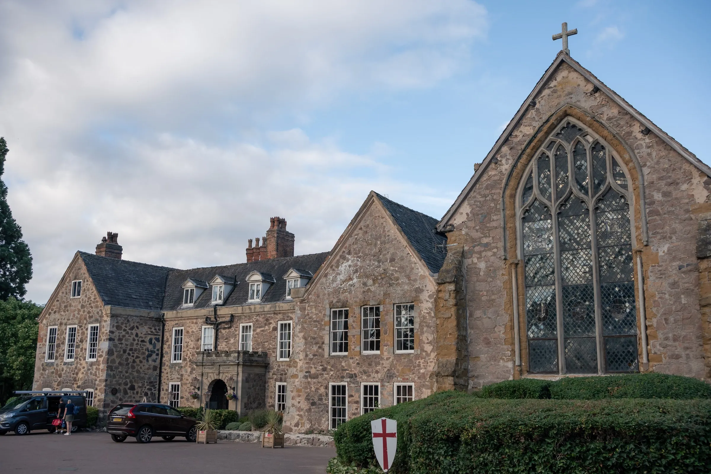 Rothley Court's stone manor house and chapel under a blue sky in Rothley, Leicestershire