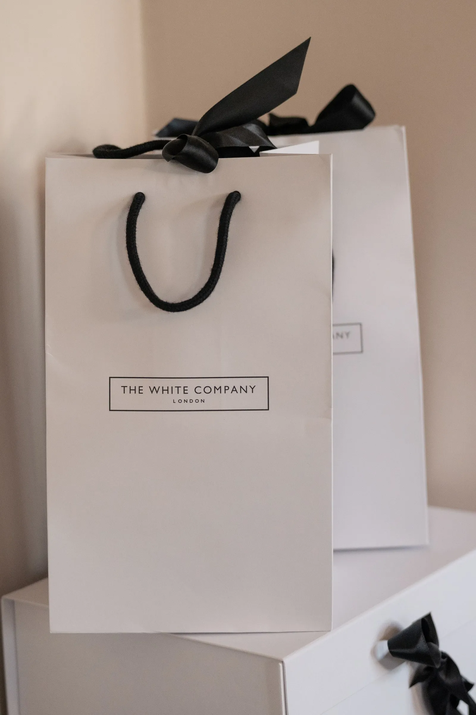 White gift bag with a black ribbon