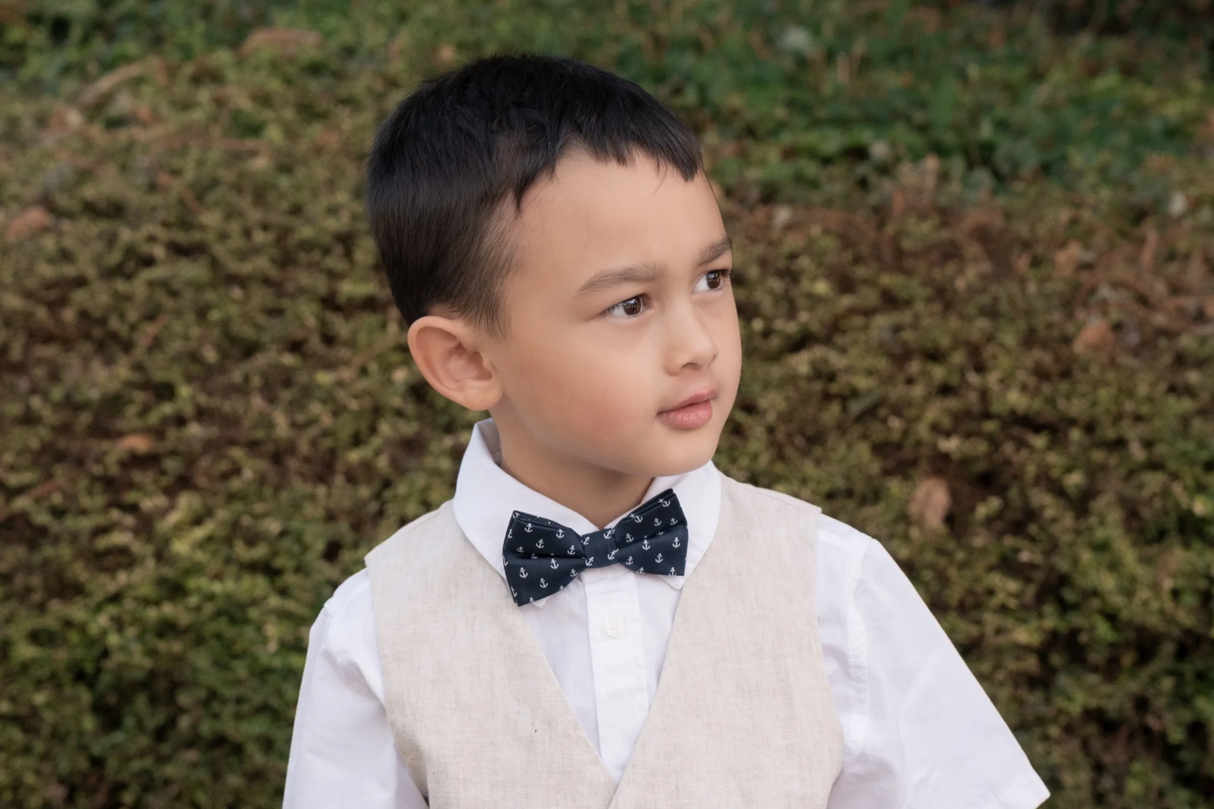 Close portrait of Mathelle's son in a navy bow tie