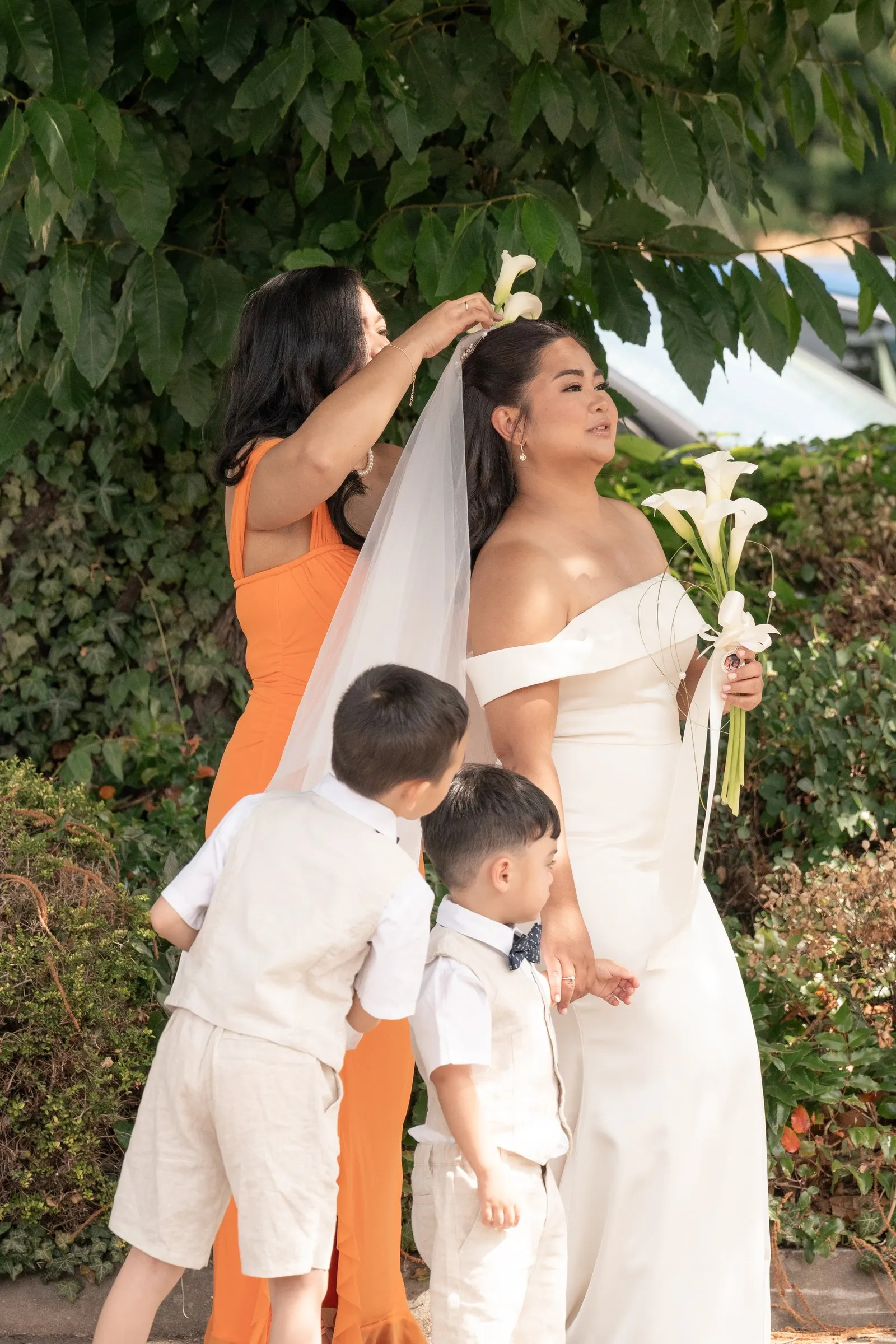 Mathelle with her two sons and a bridesmaid in the garden