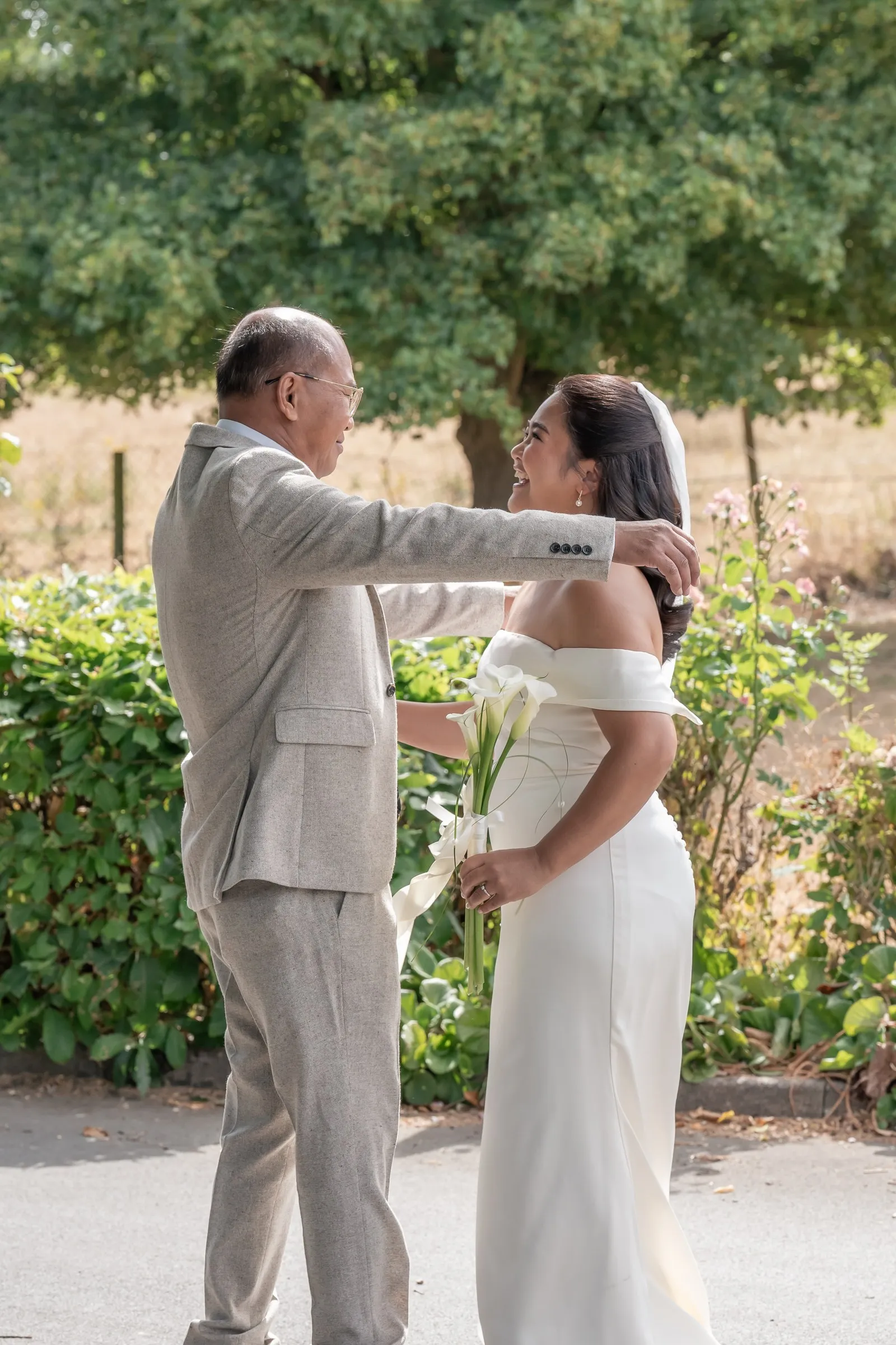 Mathelle's dad reaching to embrace her during their first look