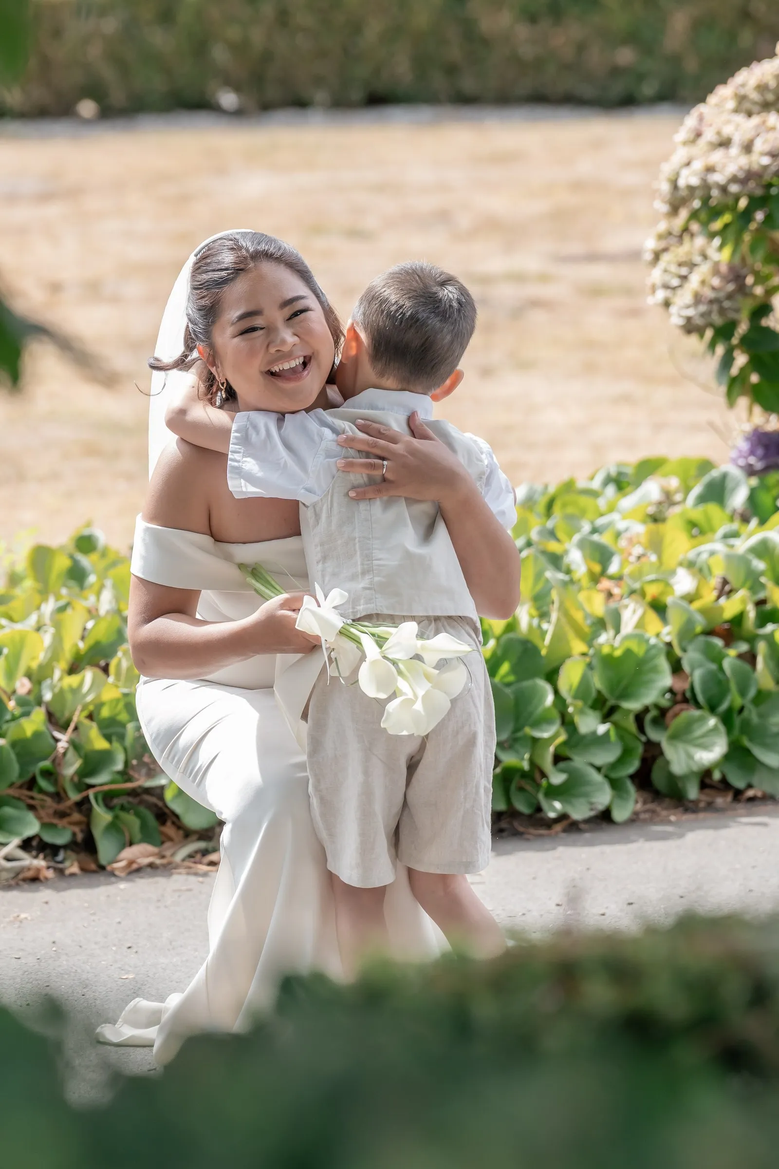 Mathelle holding her son close and laughing during their first look at Rothley Court
