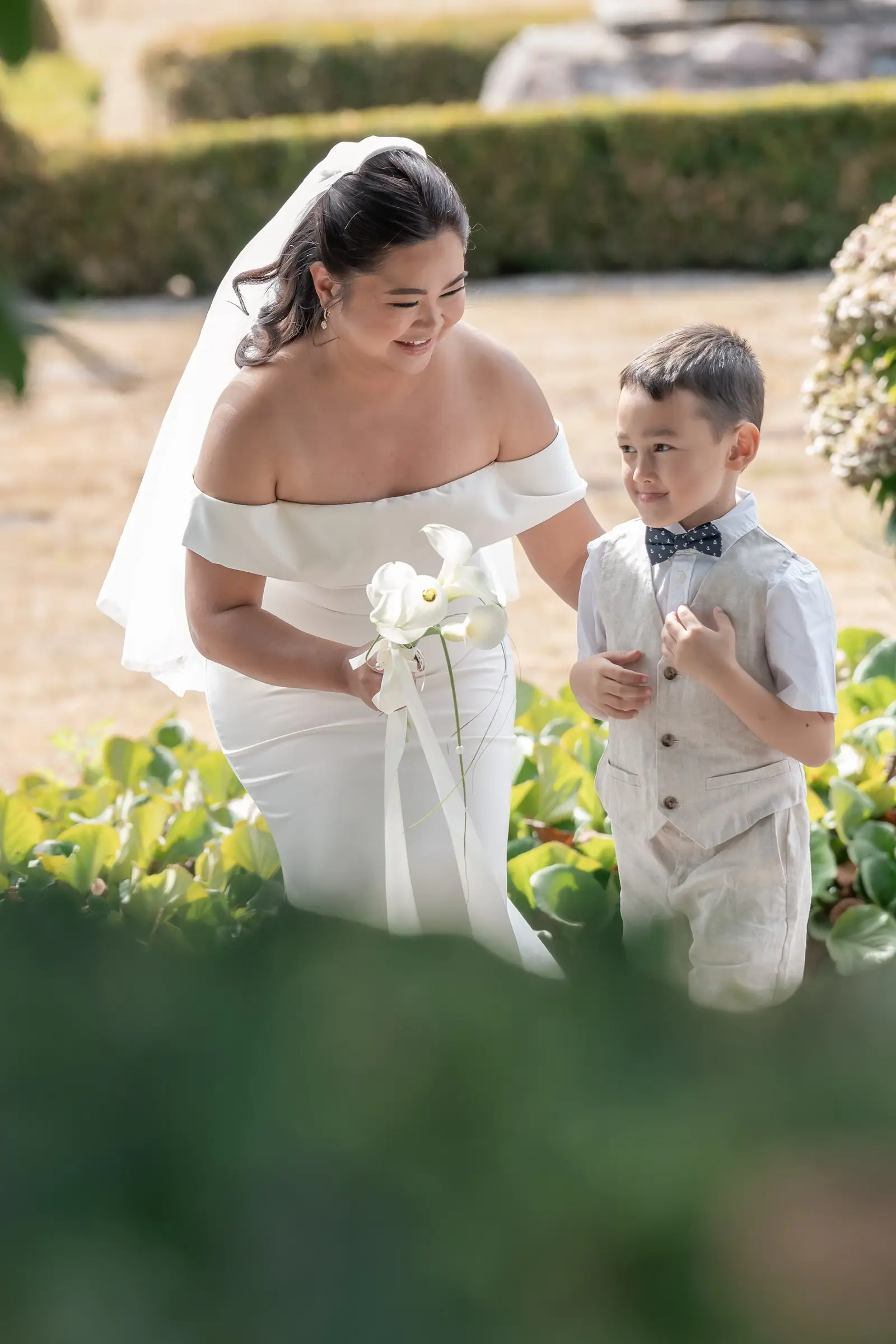 Mathelle's son handing her the calla lily bouquet she would carry down the aisle