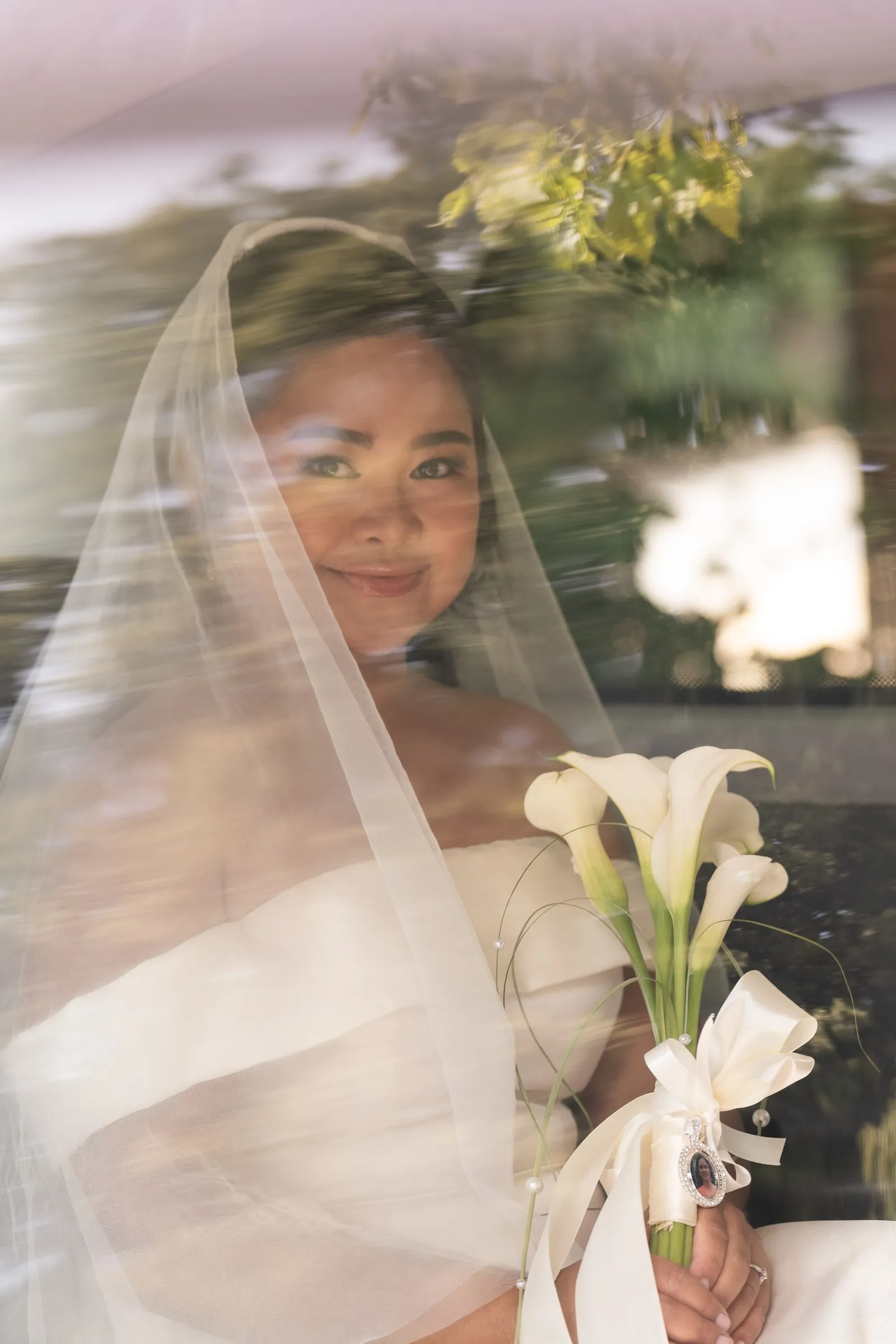 Mathelle seen through the taxi window holding her bouquet
