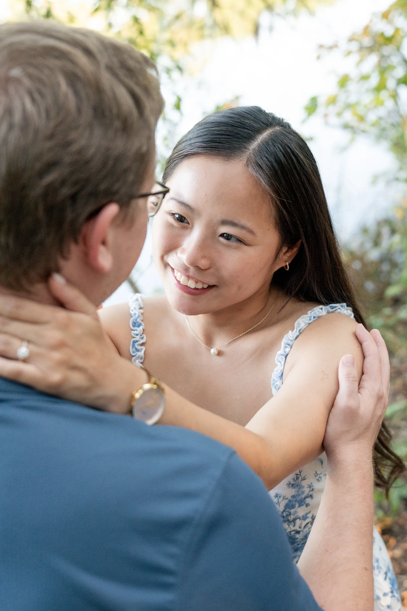 Mya smiling up at Jacob with her hand on his shoulder, engagement ring in view