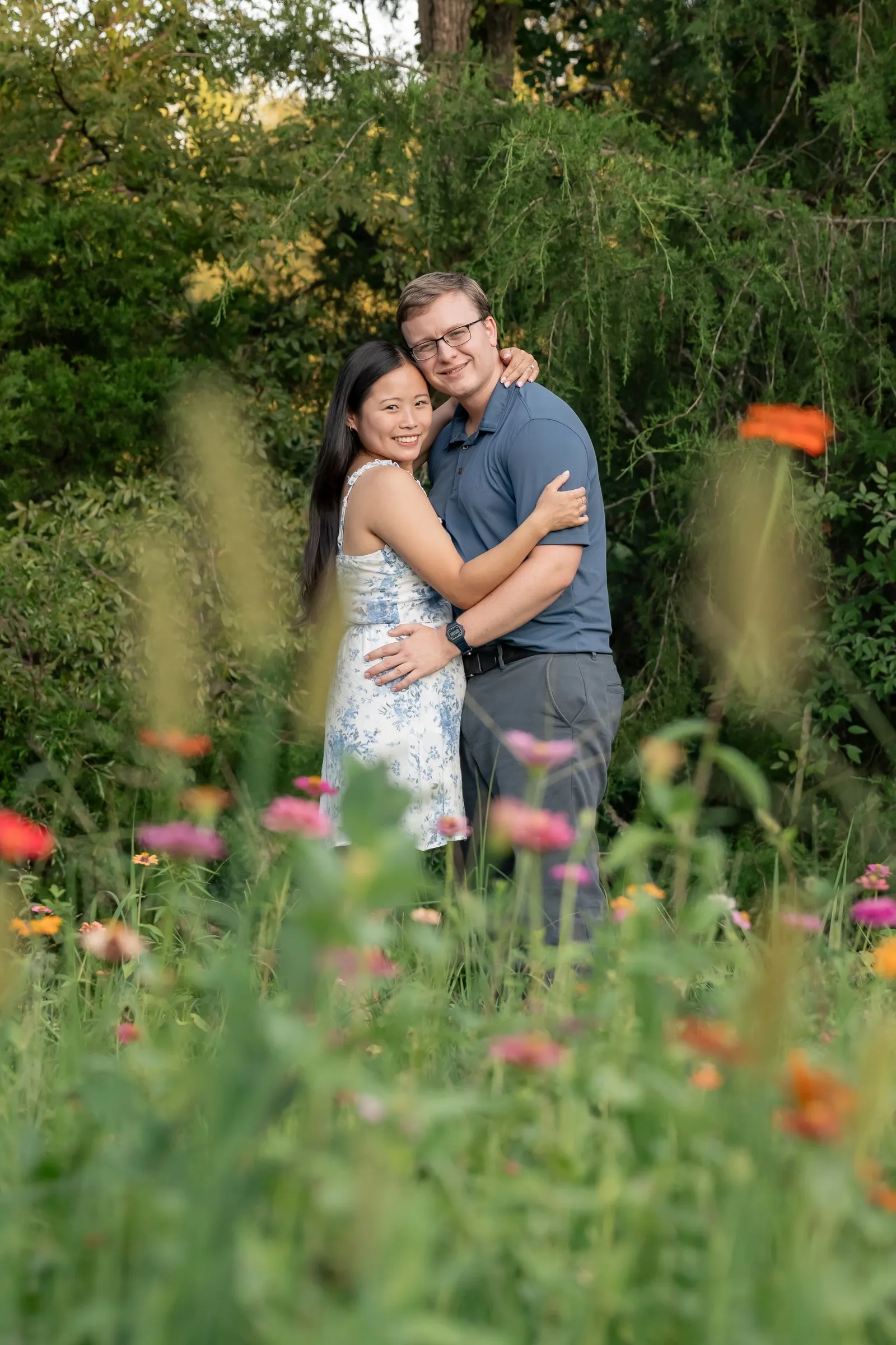 Mya and Jacob standing in tall wildflowers at Marvin Efird Park in Waxhaw, NC