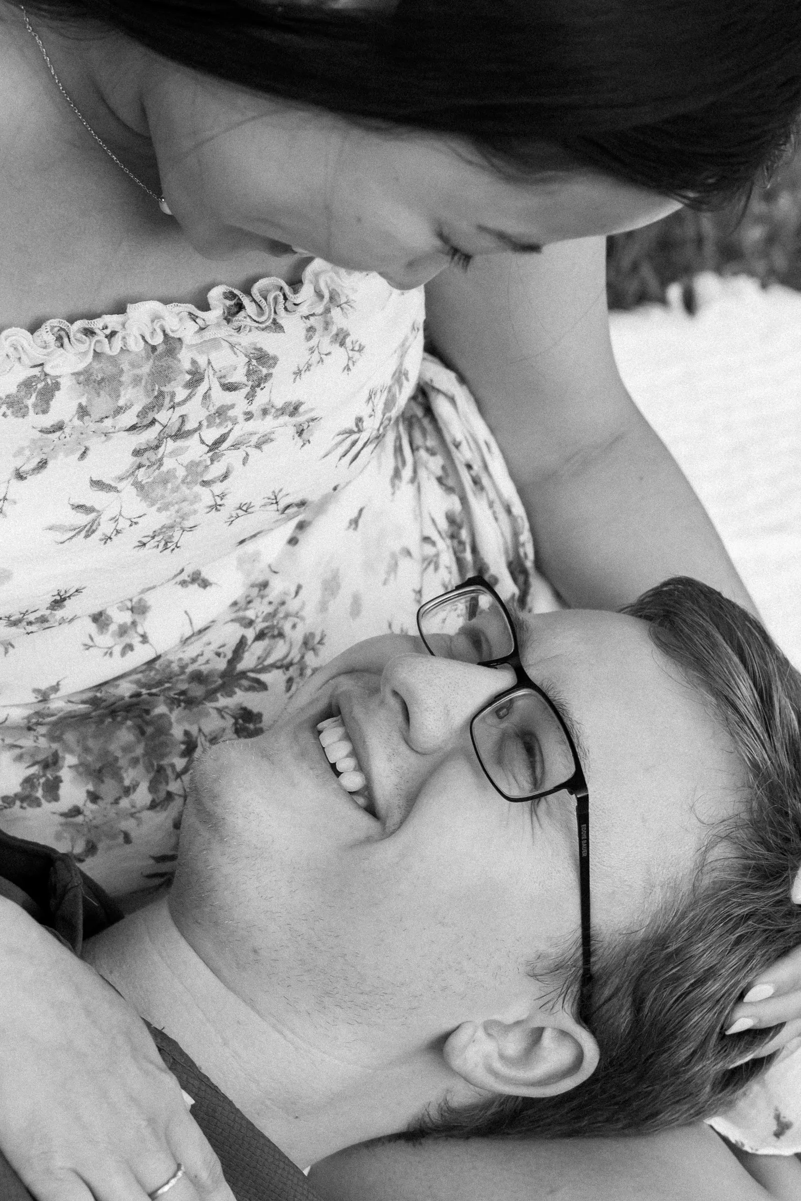 Black and white overhead frame of Jacob smiling up at Mya