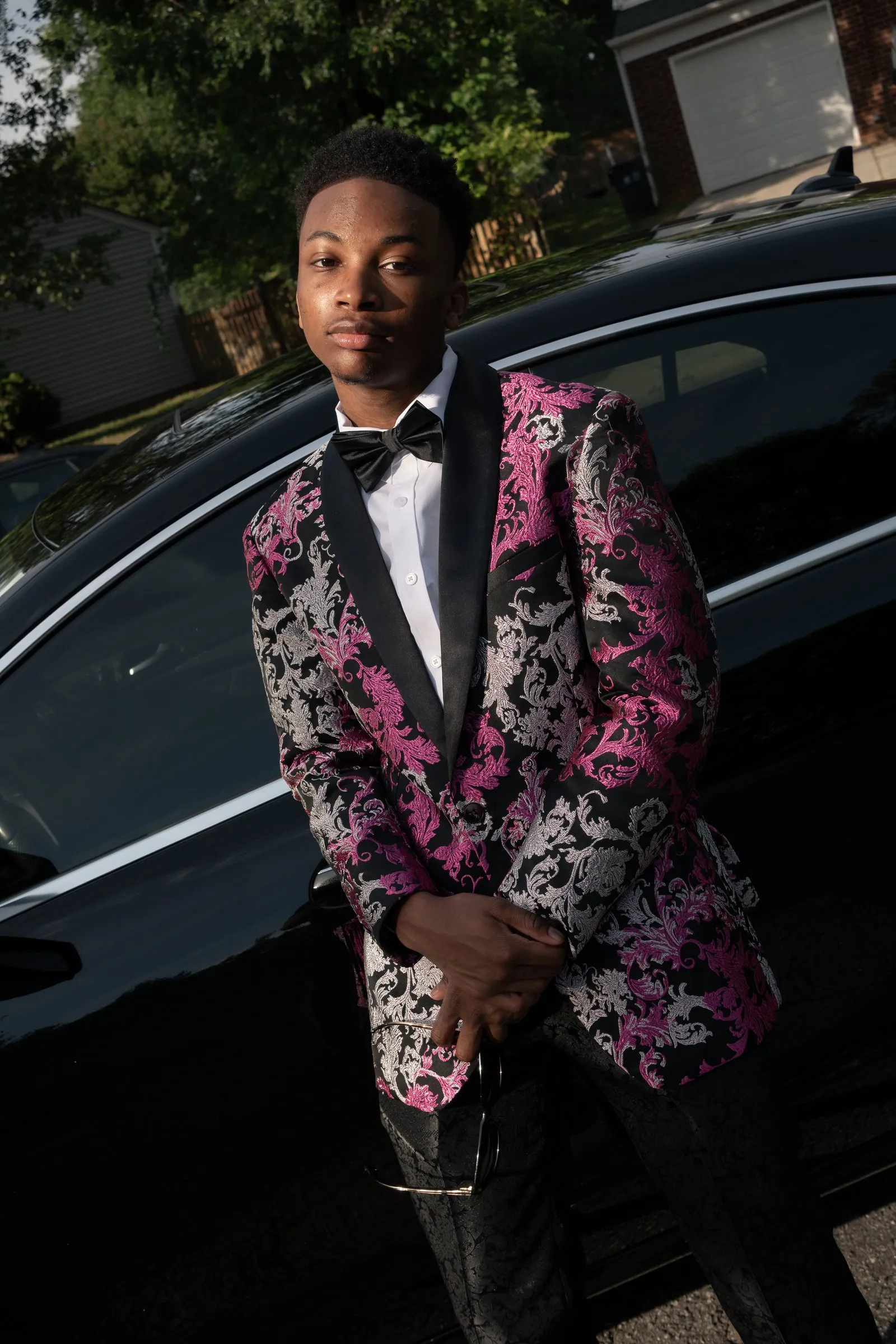 Close portrait against the gloss of the black Mercedes
