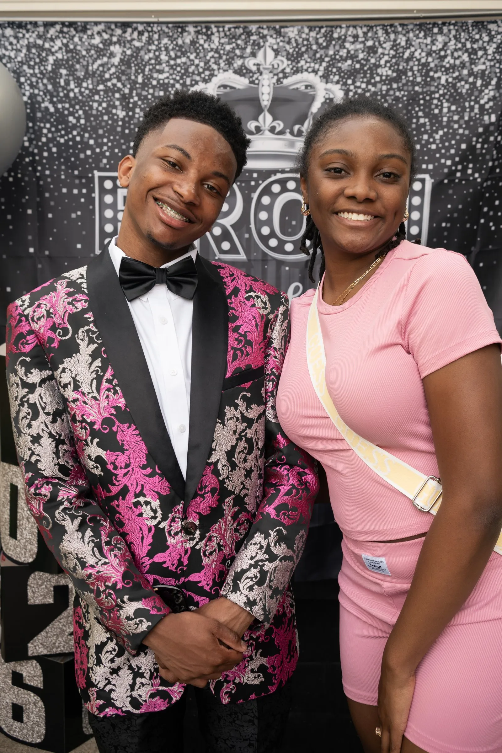 Big grins with a friend in pink at the send-off backdrop