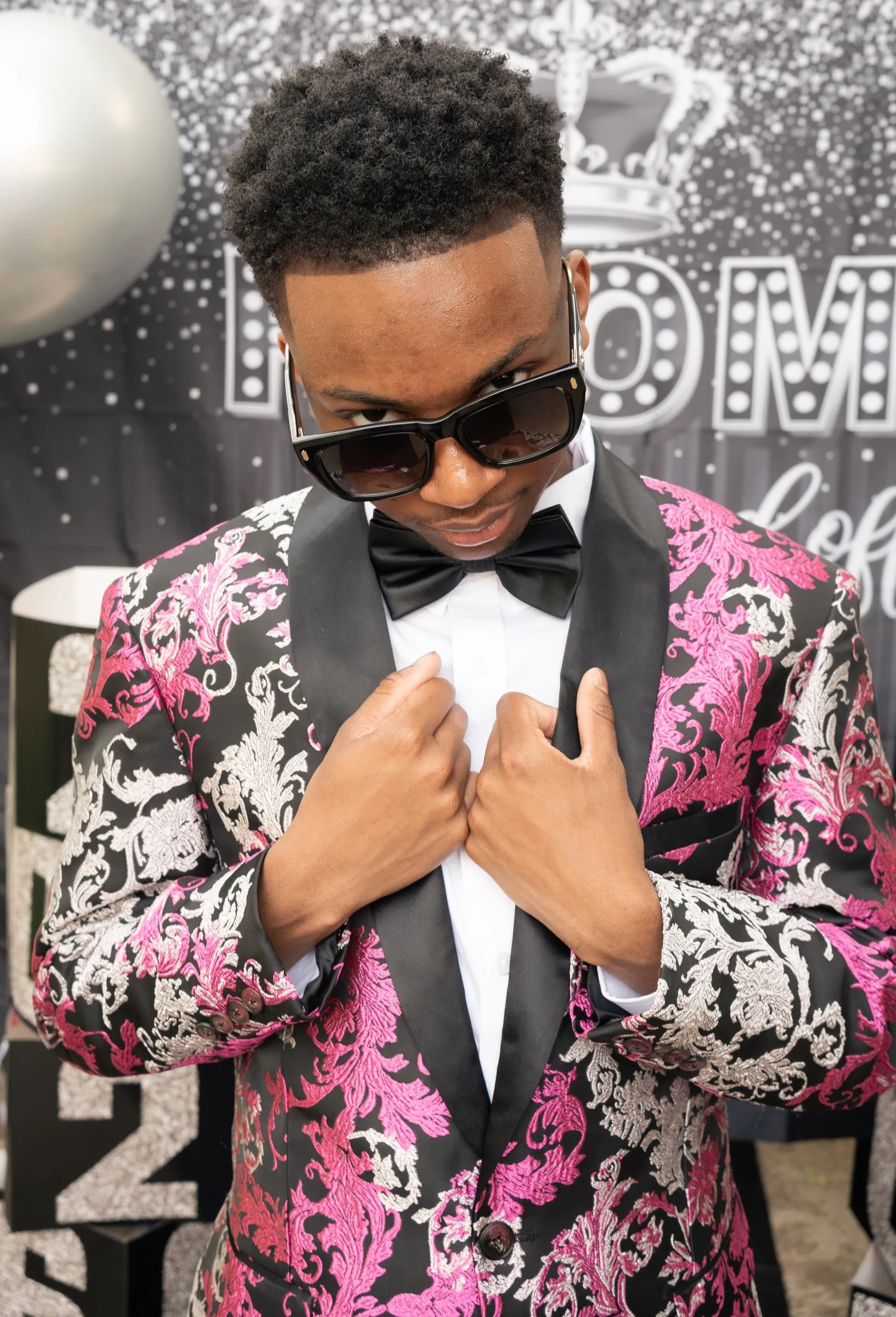 Close portrait in sunglasses with both hands on his lapels