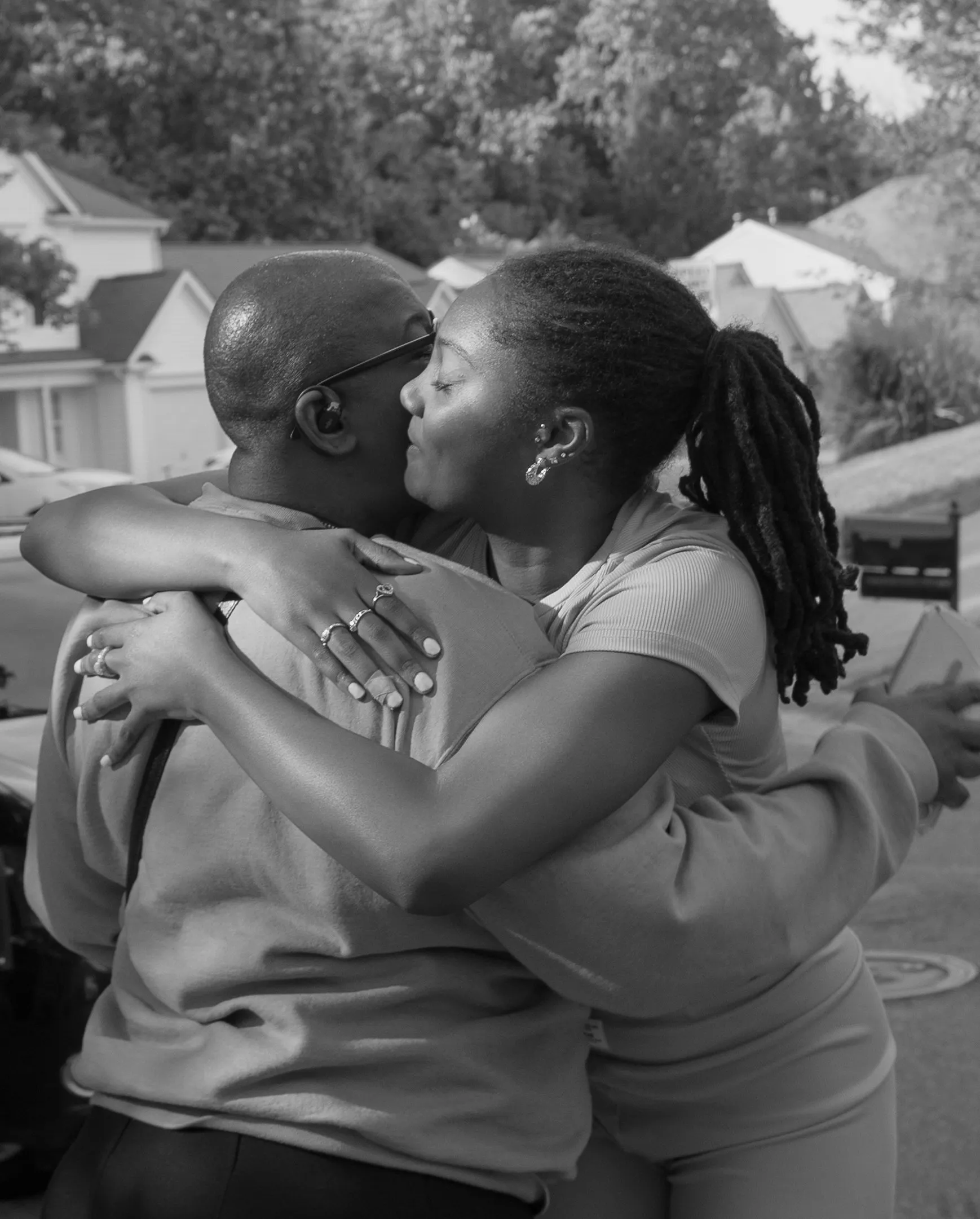 Black and white photograph of two guests in a warm embrace