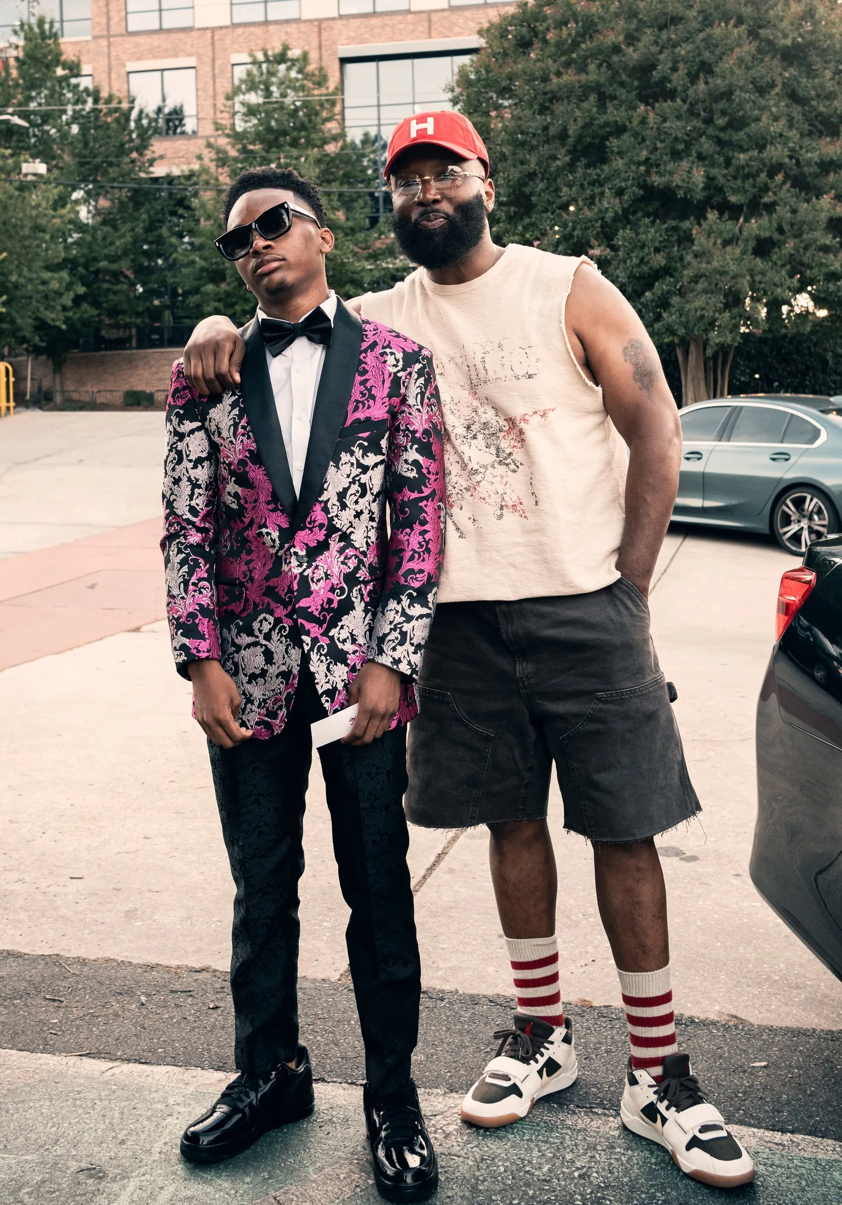 He poses with a man in a red cap outside The Hamilton