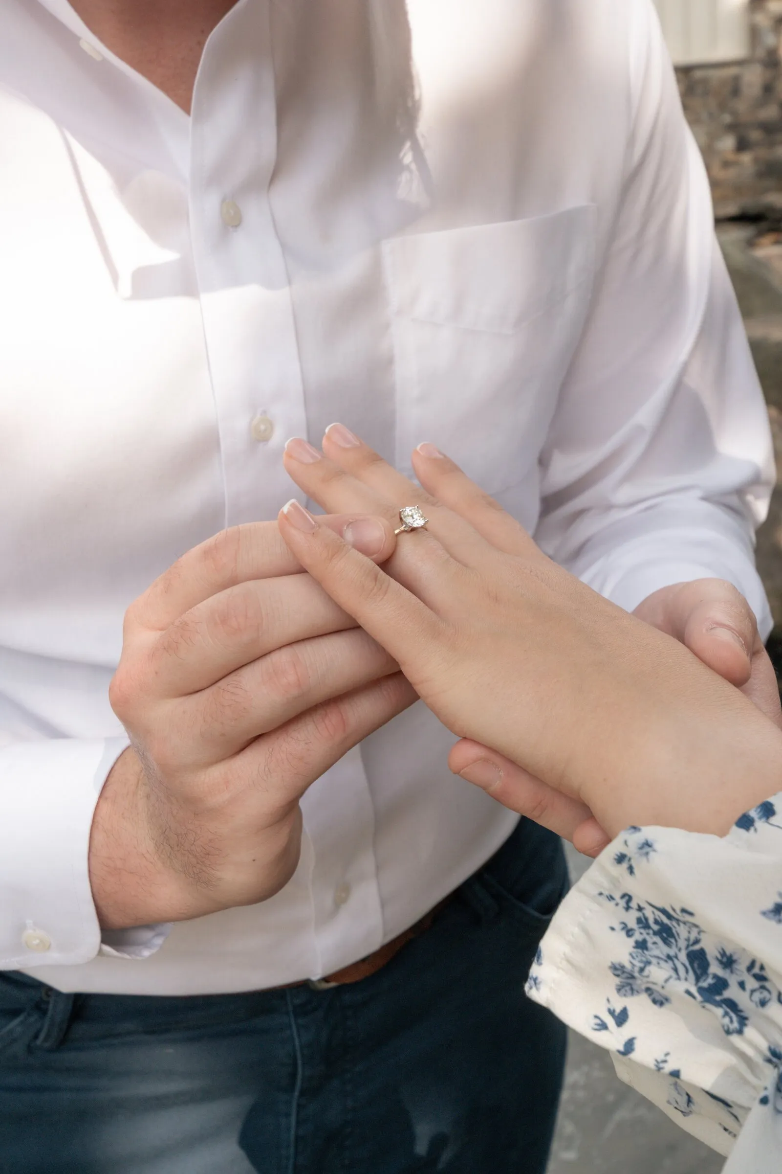 Spencer slipping the engagement ring onto Kayla's finger