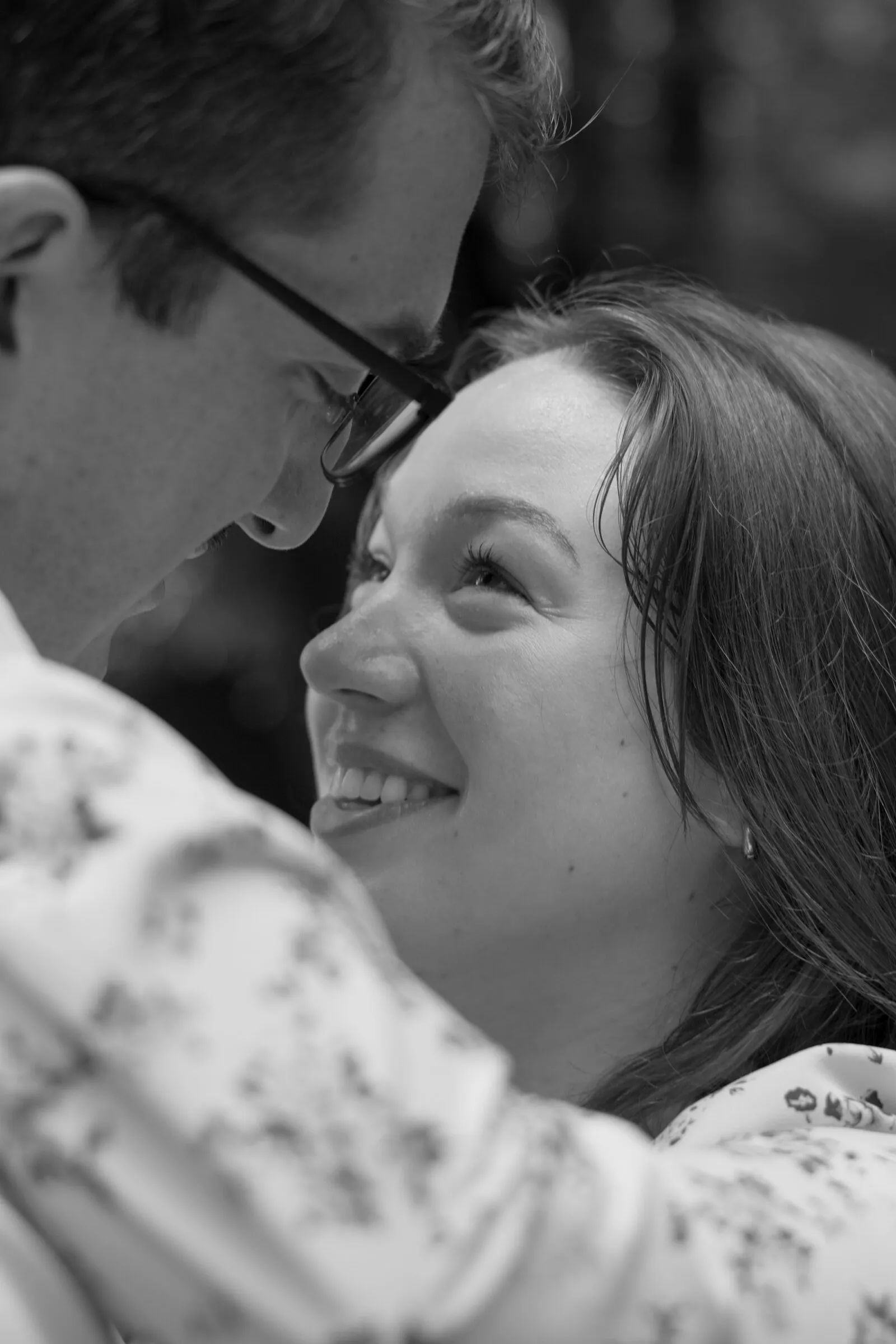 Black and white close-up of Spencer and Kayla forehead to forehead, Kayla smiling